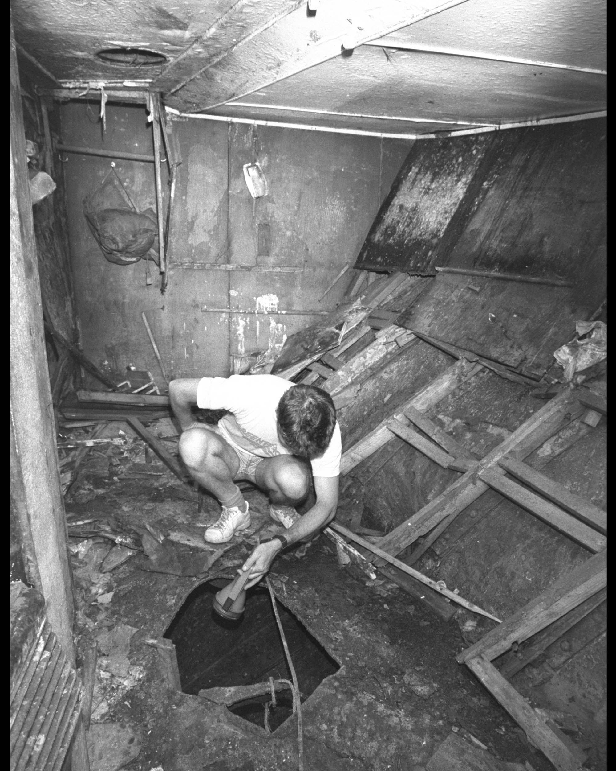 Inspecting the damage to the Rainbow Warrior after the bombing.  Image courtesy of Greenpeace.